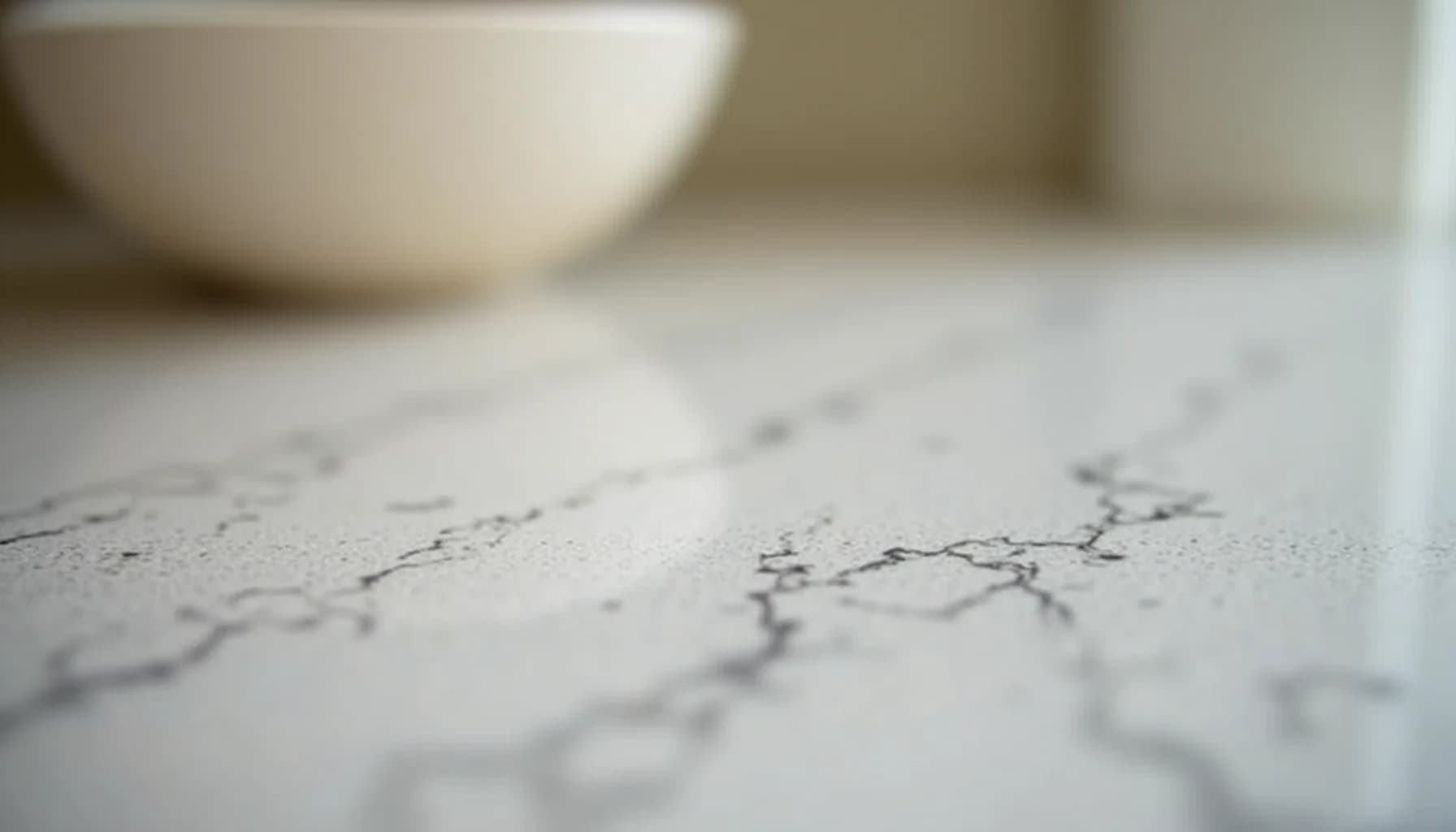 cracked marble surface with blurred white bowl or vessel in background