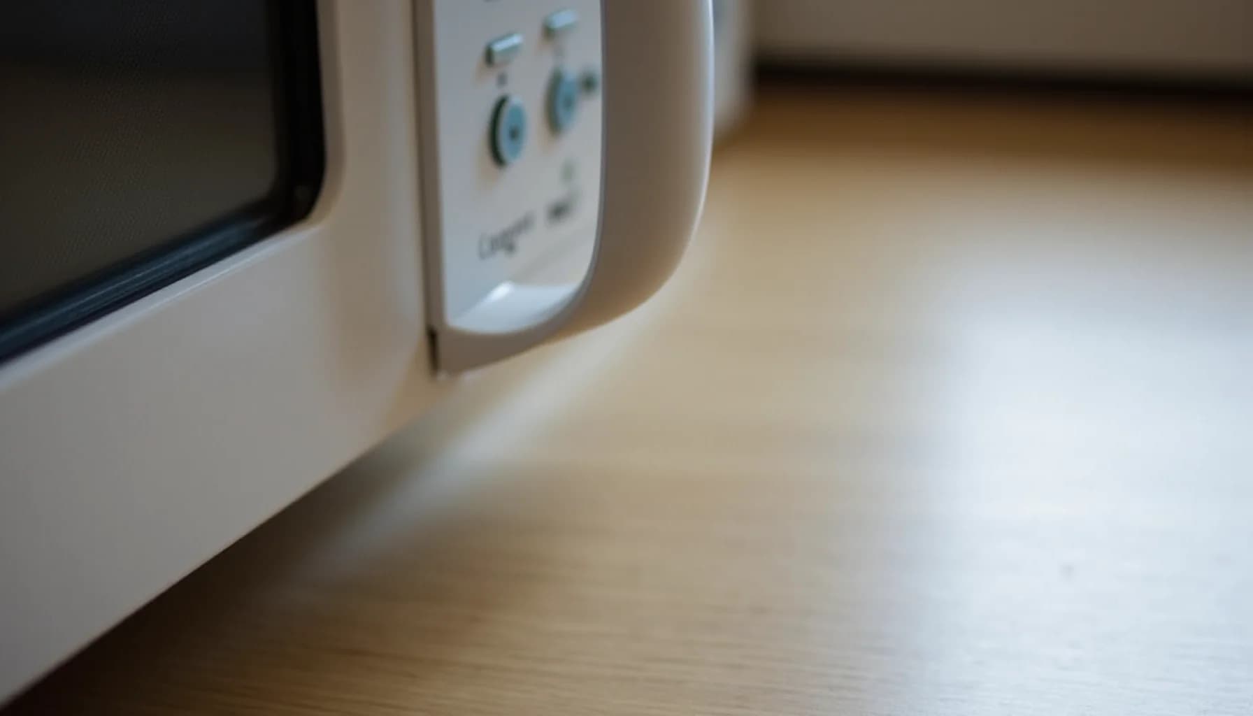 White microwave oven with control panel featuring buttons and dials, sitting on a wooden surface